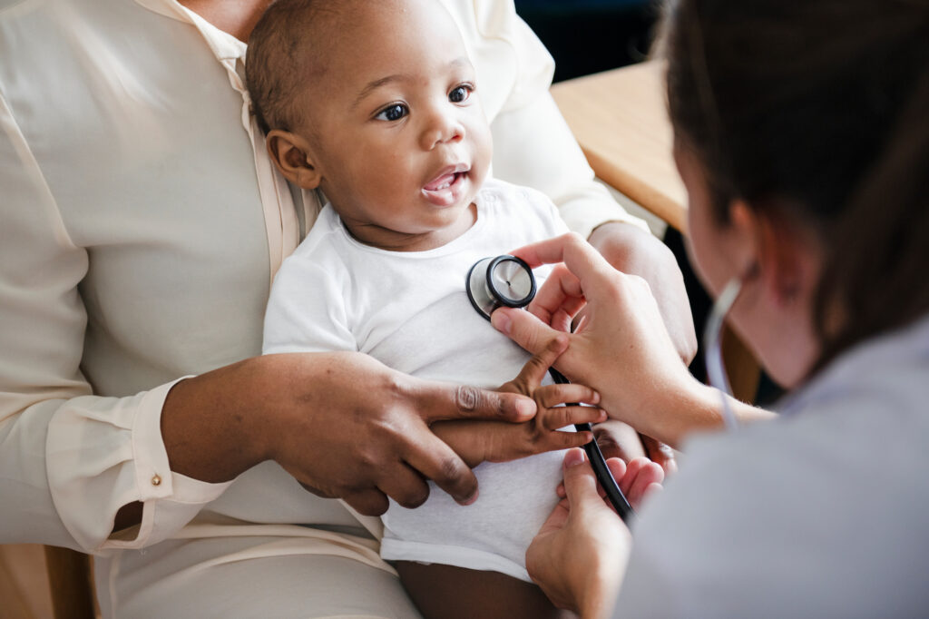 An Oak Lawn pediatrician checking a baby’s heartbeat with the use of a stethoscope.